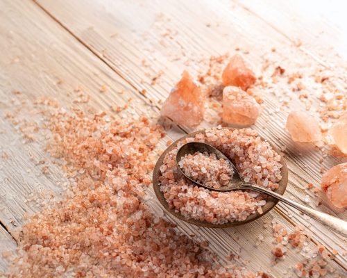 Himalayan pink salt in bowl on wooden background